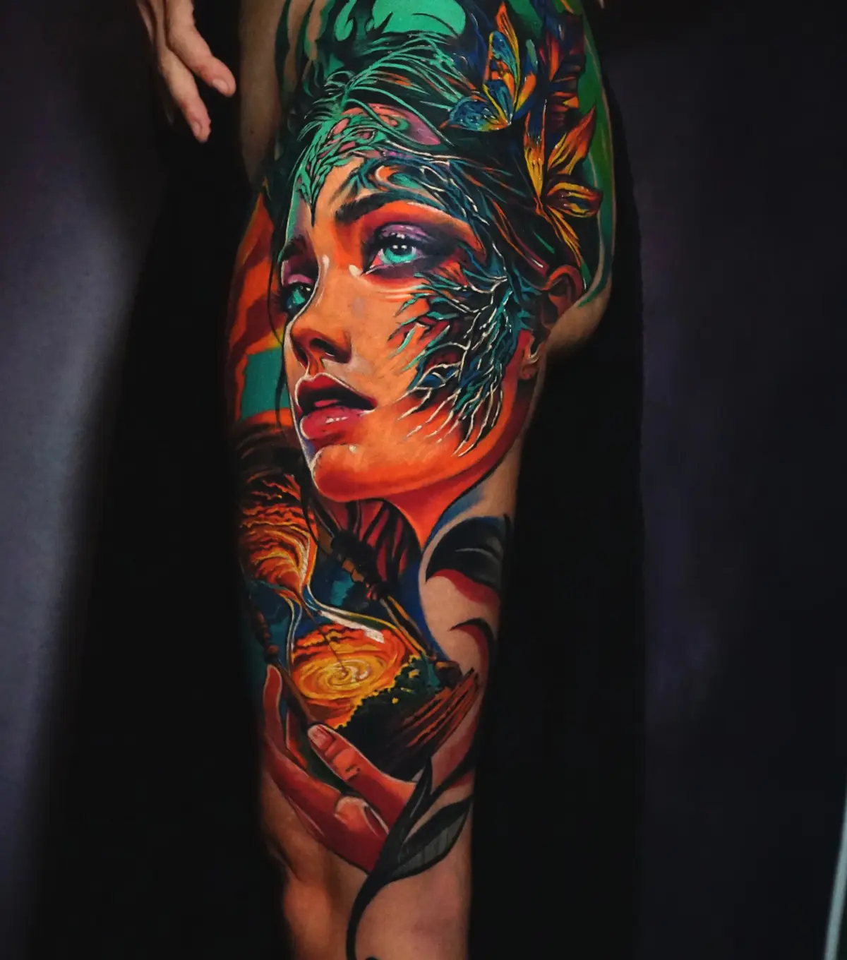 Color fantasy woman sleeve tattoo with saturated orange, teal, blue, and red details