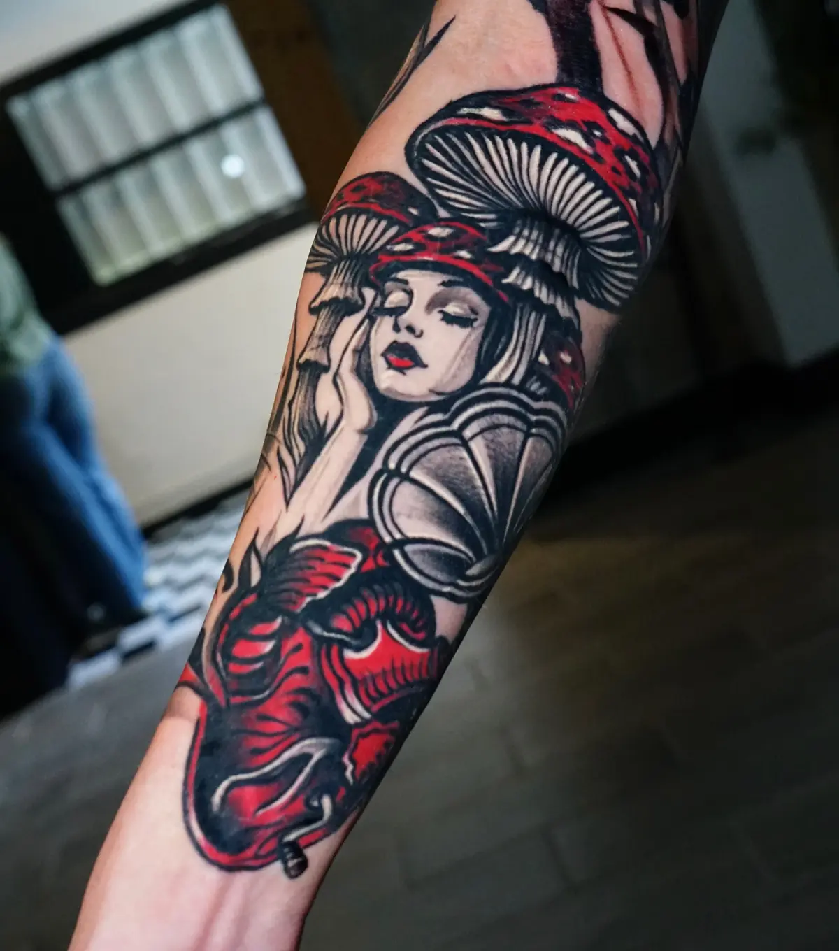 Neo-traditional mushroom sleeve tattoo with a woman, red mushrooms, and a moth