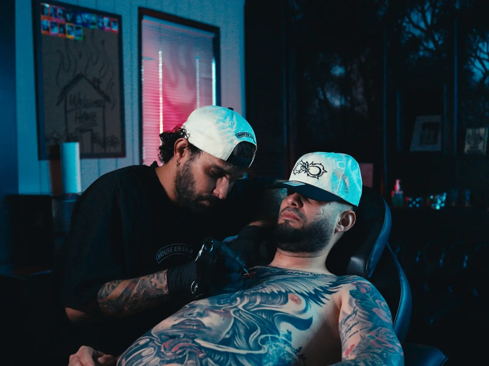 Tattoo artist working with a client inside the Miami studio